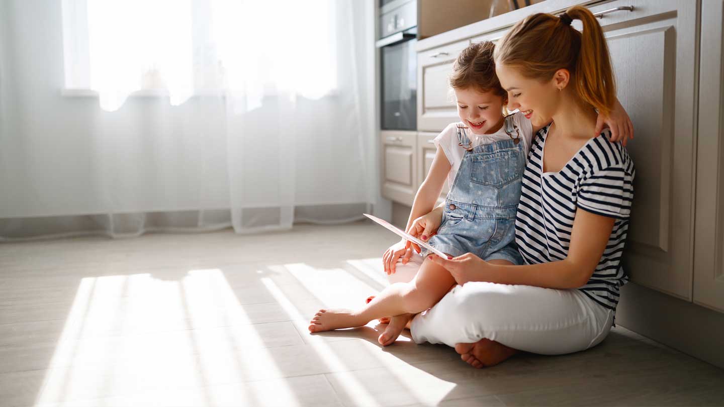 Mother and her child playing games on the tablet